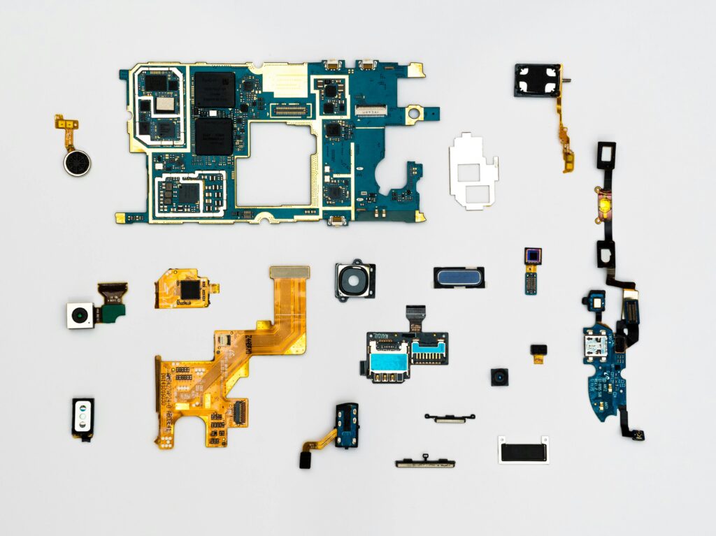 pexels-photo-1476321-1476321 Exploded view of smartphone components showcasing intricate technological design.